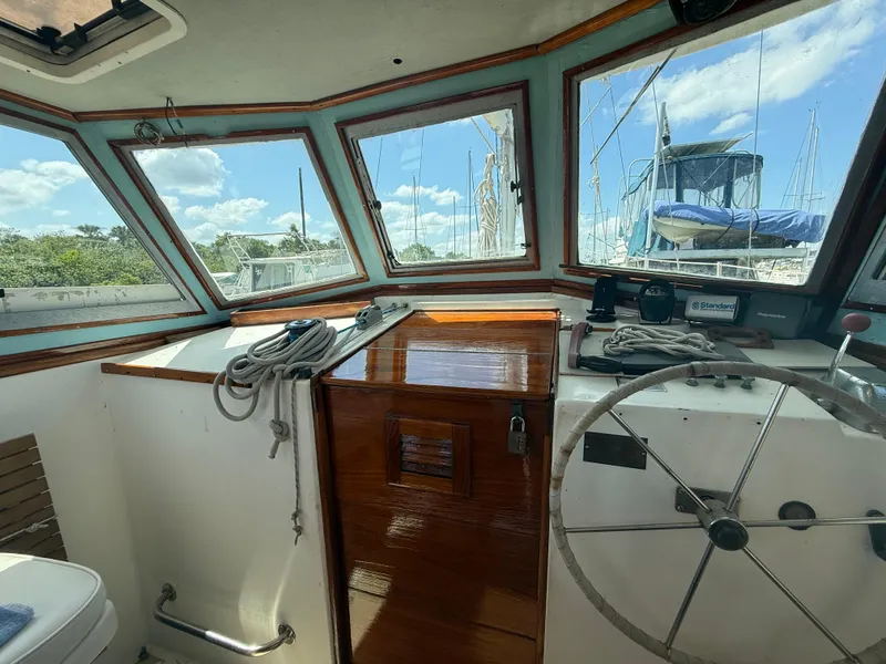 Slide: The Image of Interior of 1986 Cape Dory MS300 boat with steering wheel and windows. - 17