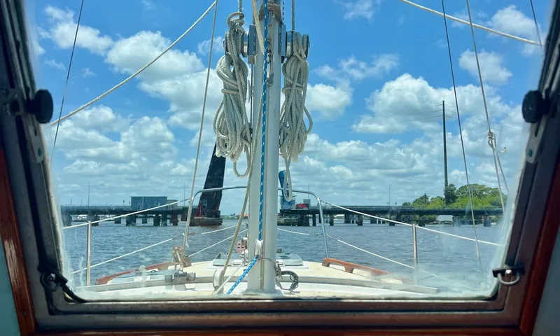 Slide: The Image of View from 1986 Cape Dory MS300 sailboat, clear sky, calm waters, bridge ahead. - 19