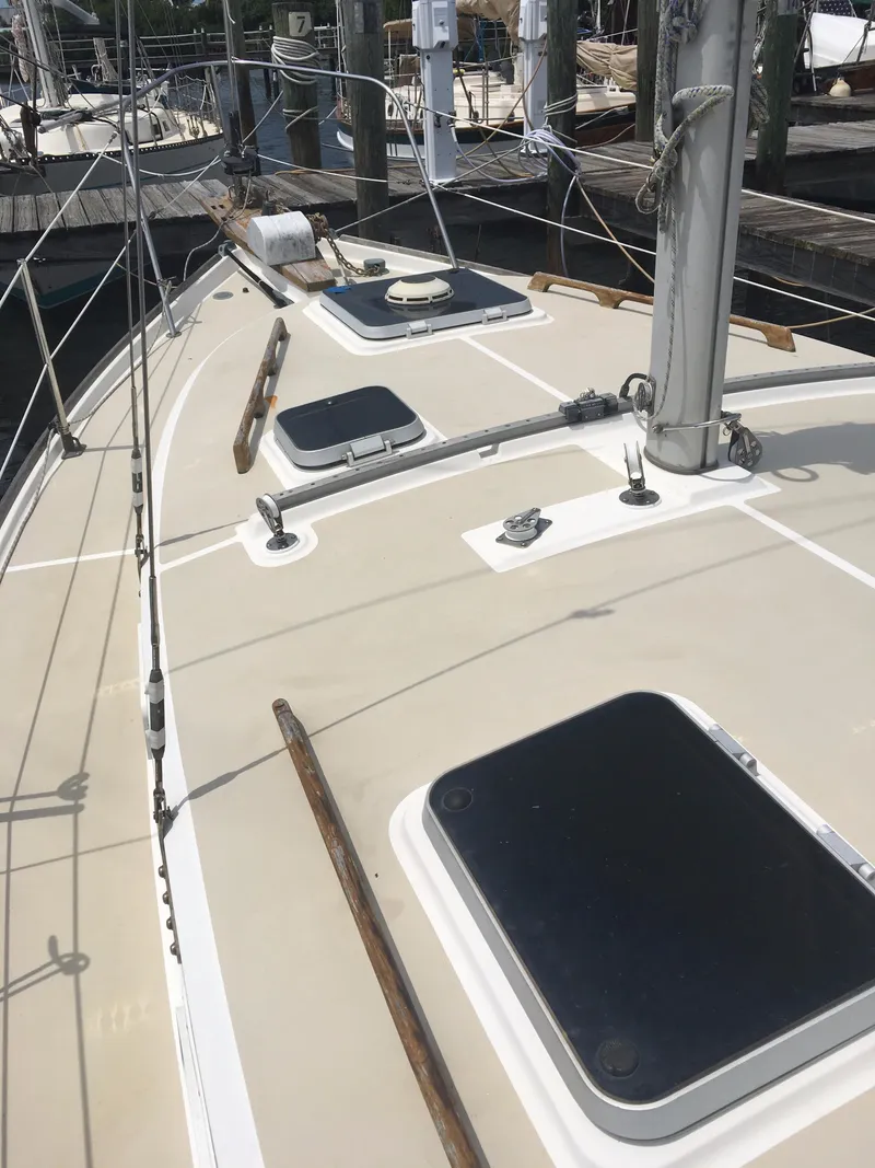Slide: The Image of 1986 Cape Dory MS300 sailboat deck with hatches and rigging at a marina. - 24