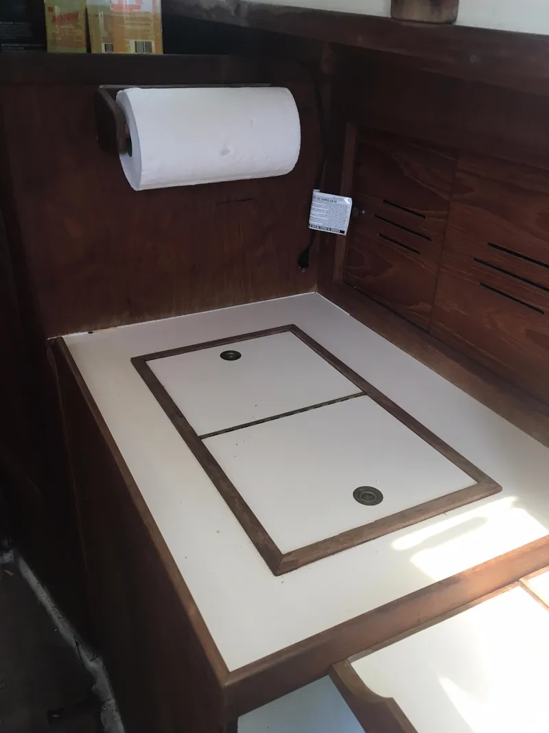 Slide: The Image of 1986 Cape Dory MS300 galley with wooden cabinetry and paper towel holder. - 39