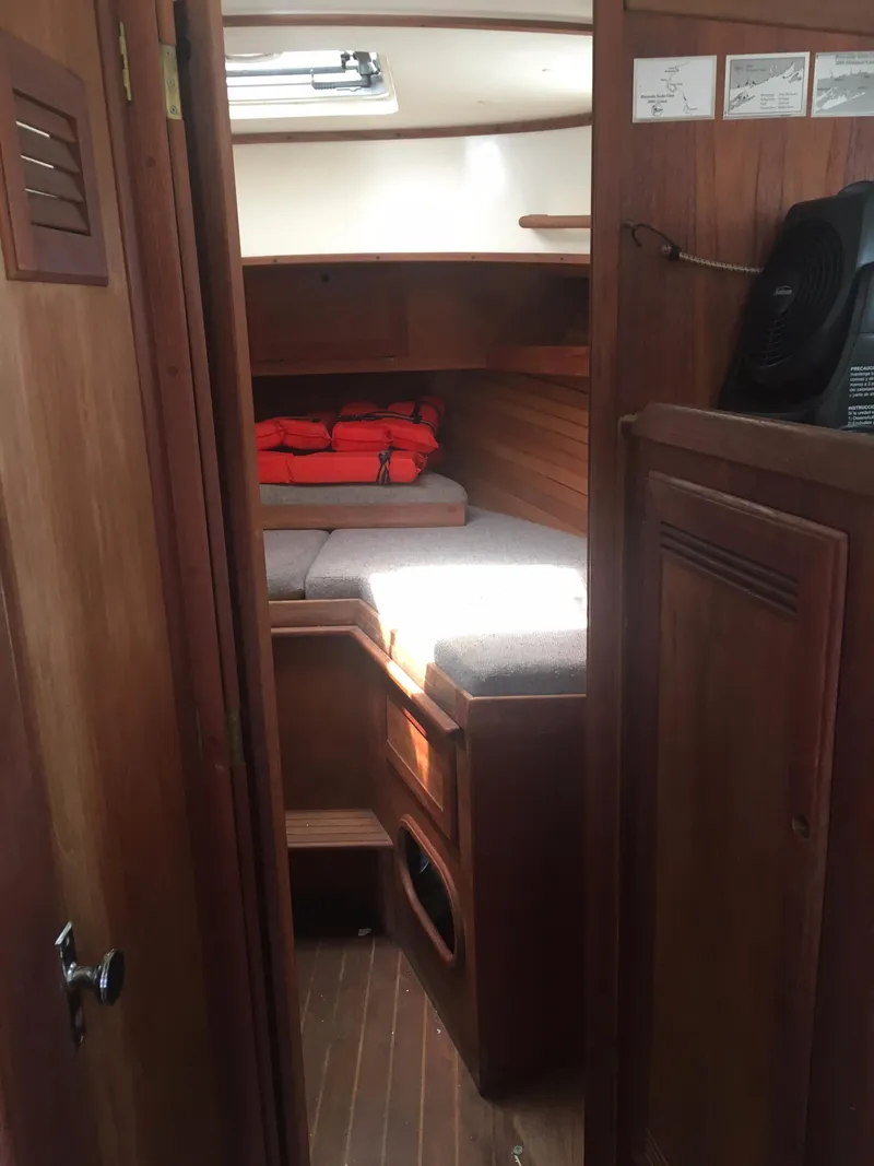 Slide: The Image of 1986 Cape Dory MS300 cabin interior with wooden finish and cozy sleeping area. - 41
