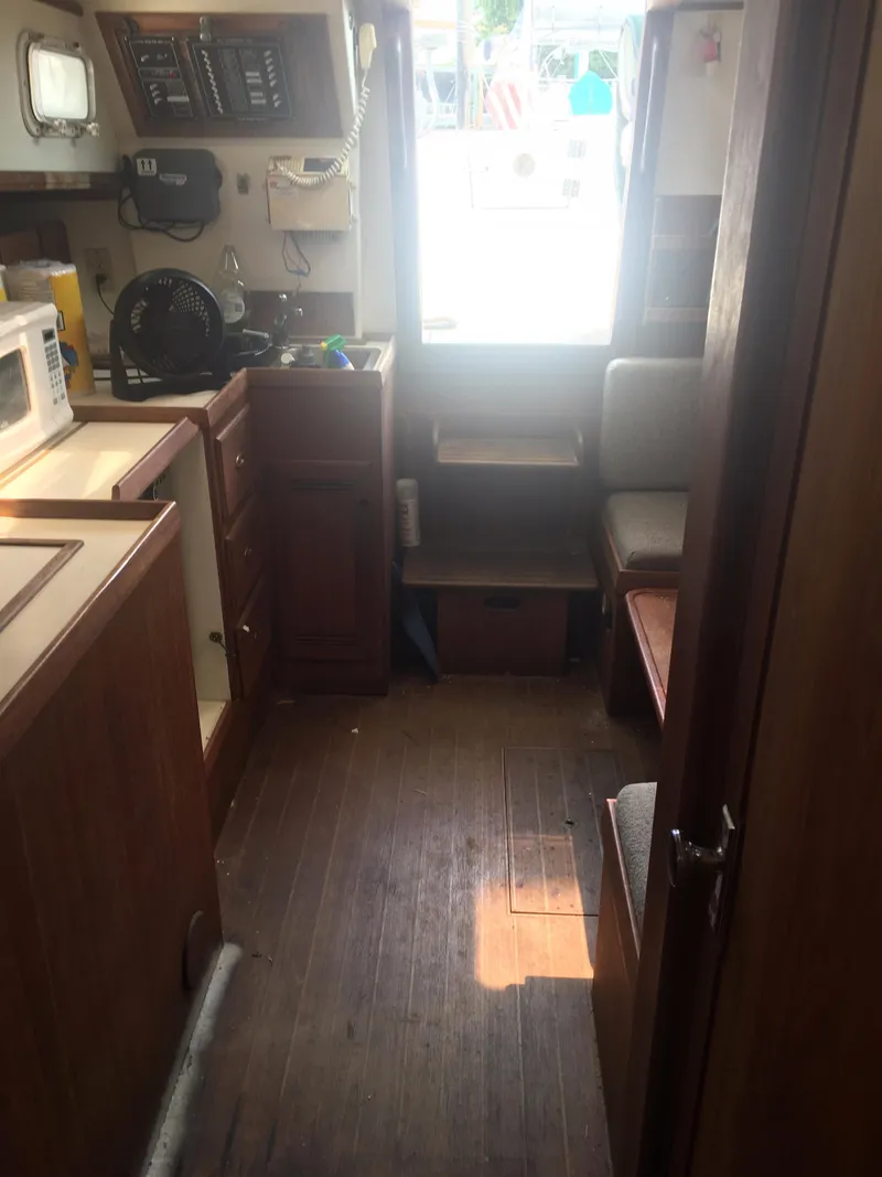 Slide: The Image of Interior of 1986 Cape Dory MS300 boat with wooden cabinetry and seating area. - 44