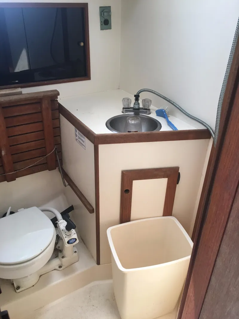 Slide: The Image of Compact bathroom in 1986 Cape Dory MS300 boat with sink, toilet, and storage. - 45