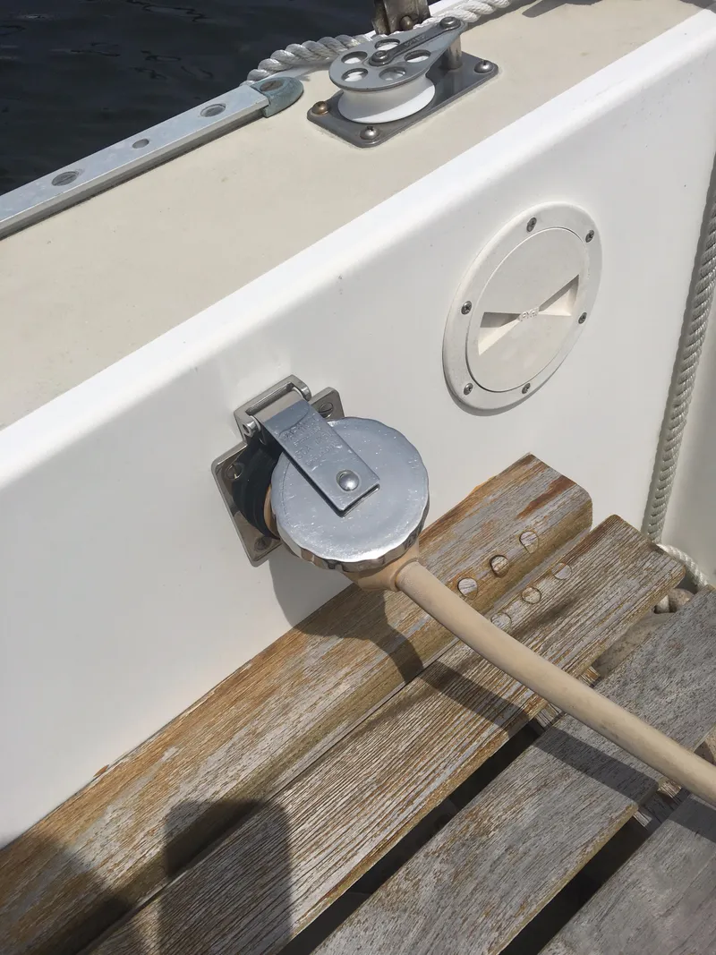 Slide: The Image of 1986 Cape Dory MS300 boat deck with power connection and wooden seating. - 47
