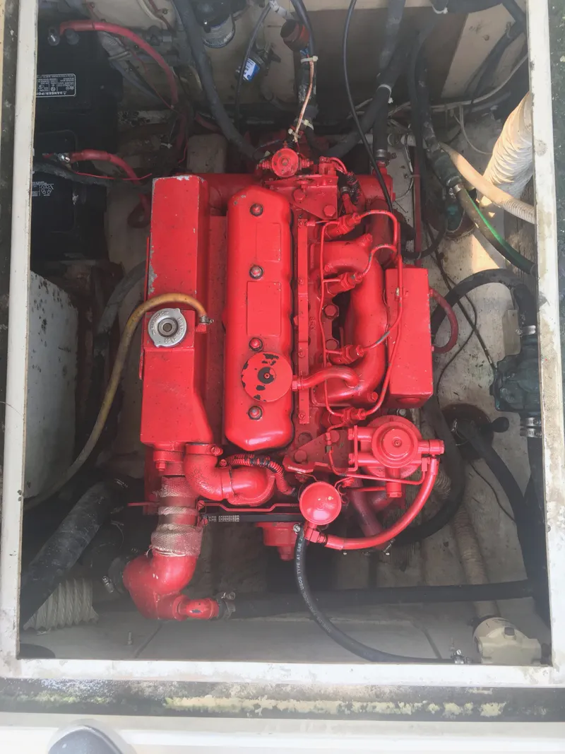 Slide: The Image of Red engine of a 1986 Cape Dory MS300 boat, showing detailed components. - 49