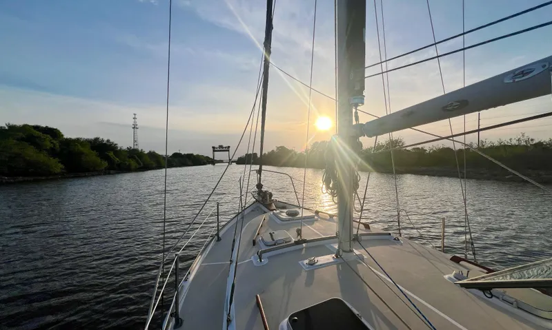 Slide: The Image of Sailing on a 1986 Cape Dory MS300 at sunset, tranquil river view. - 7