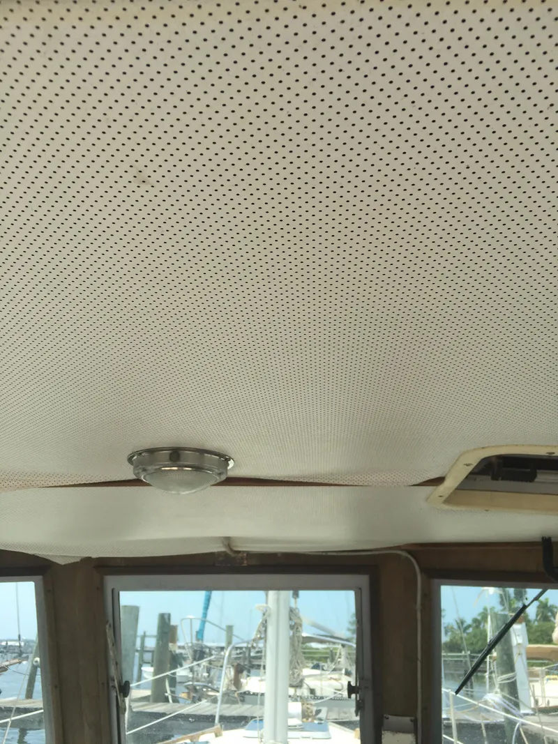 Slide: The Image of Perforated ceiling of 1986 Cape Dory MS300 boat cabin with window view. - 75