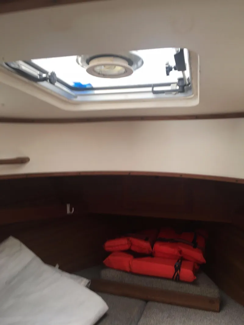 Slide: The Image of Interior cabin of 1986 Cape Dory MS300 sailboat with life jackets and open hatch. - 76