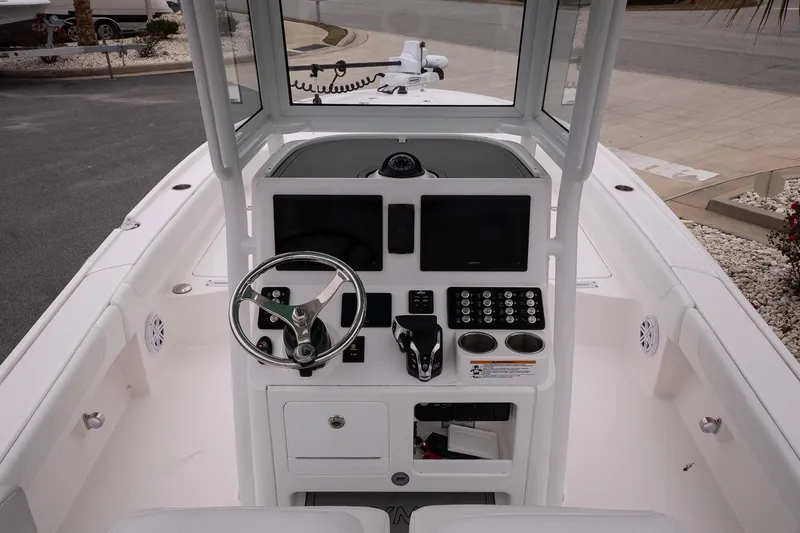 Slide: The Image of 2025 Caymas 26 HB boat console with steering wheel and electronic controls. - 11