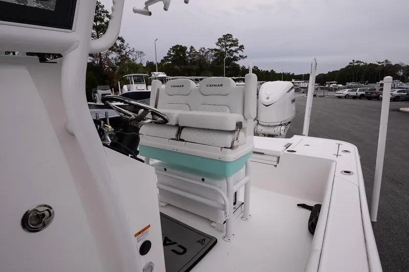 Slide: The Image of 2025 Caymas 26 HB boat interior with steering wheel and seating. - 12