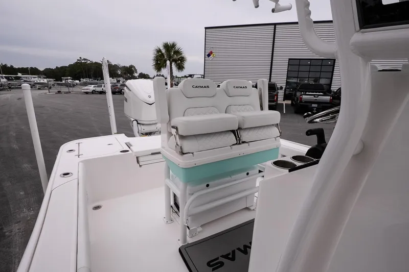 Slide: The Image of 2025 Caymas 26 HB boat interior with cushioned seating and modern design. - 13