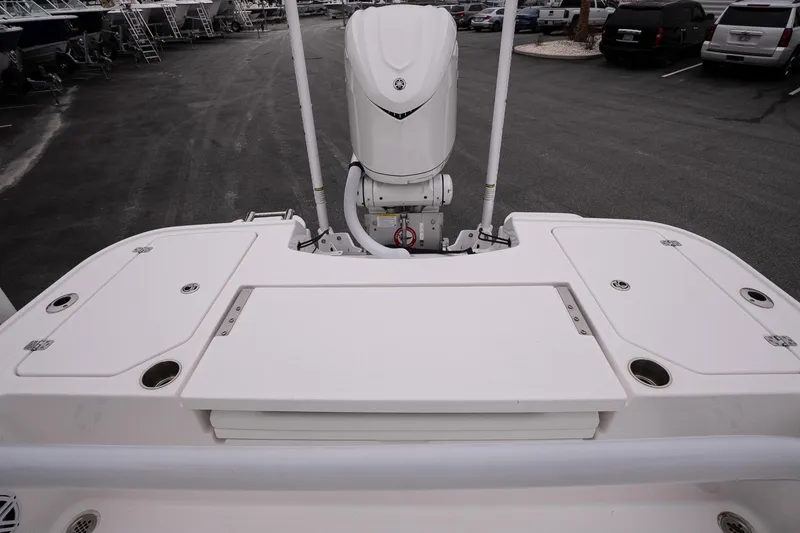 Slide: The Image of 2025 Caymas 26 HB boat stern view with outboard motor in parking lot. - 14