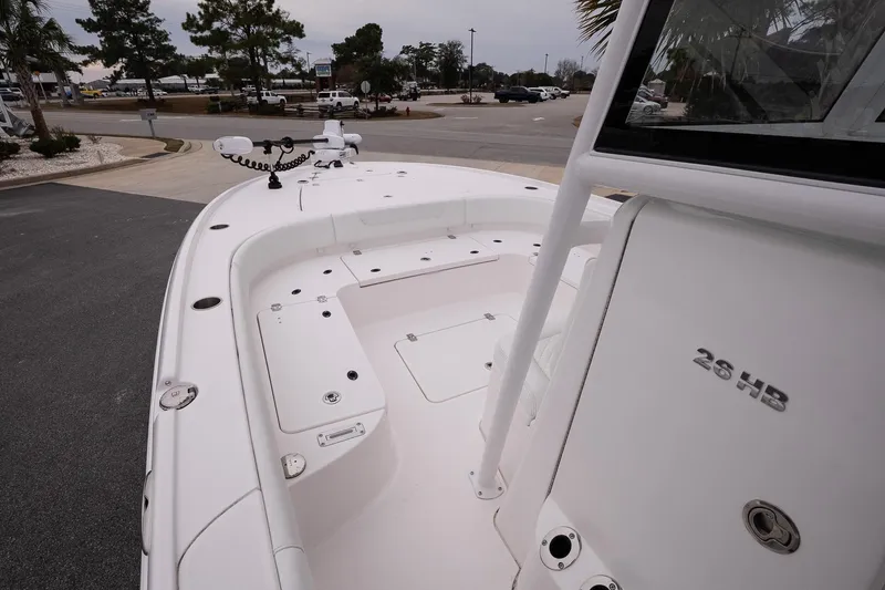Slide: The Image of 2025 Caymas 26 HB boat deck with seating and storage compartments. - 16