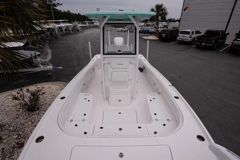 Slide: The Image of 2025 Caymas 26 HB boat, white interior, docked at a marina. - 19