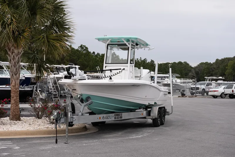 Slide: The Image of 2025 Caymas 26 HB boat on trailer in marina parking lot. - 3