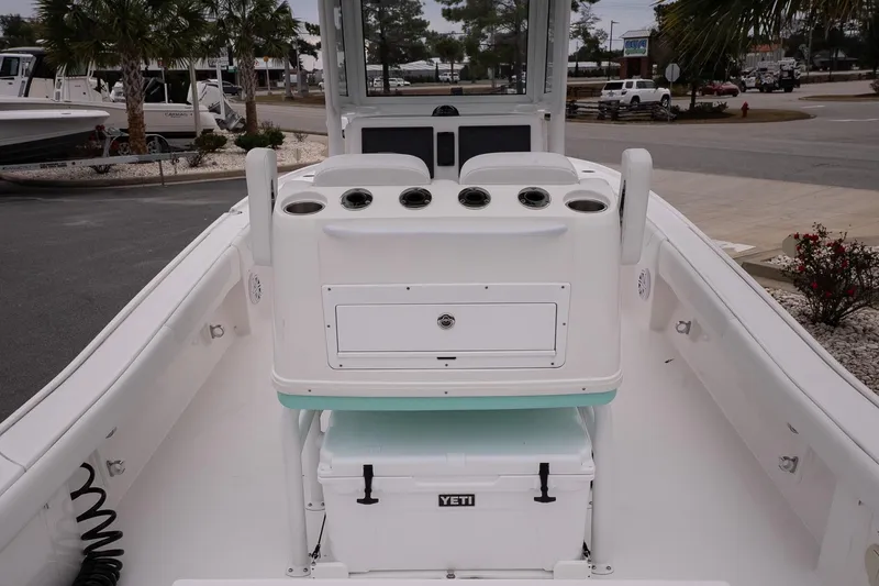 Slide: The Image of 2025 Caymas 26 HB boat interior with Yeti cooler and rod holders. - 9