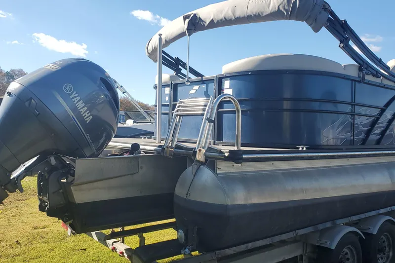 Slide: The Image of 2018 Starcraft SLS 3 pontoon boat with Yamaha outboard motor on a trailer. - 13
