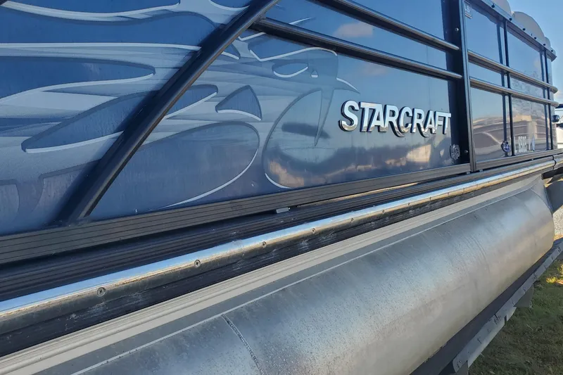 Slide: The Image of 2018 Starcraft SLS 3 pontoon boat with sleek design and branding. - 14