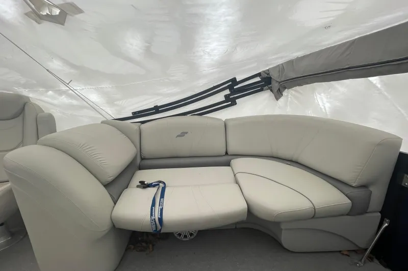 Slide: The Image of 2018 Starcraft SLS 3 boat interior with beige leather seating under a canopy. - 16