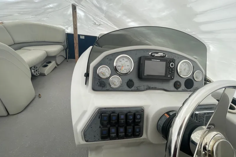 Slide: The Image of 2018 Starcraft SLS 3 boat dashboard with gauges and seating area. - 19