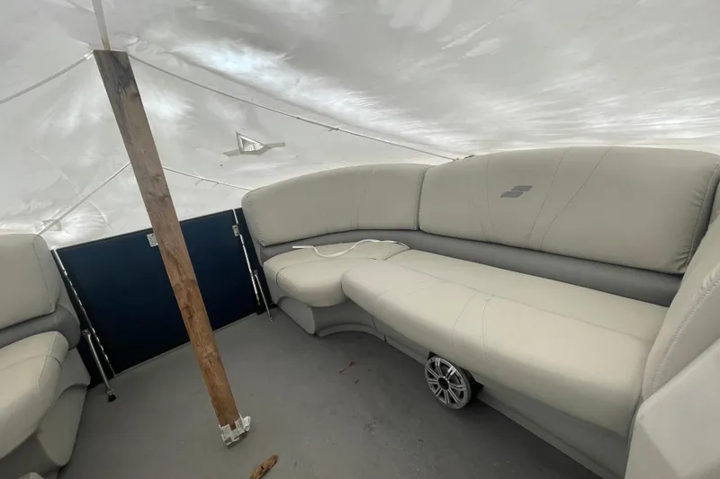 Slide: The Image of Interior of a 2018 Starcraft SLS 3 boat with beige seating under a canopy. - 21