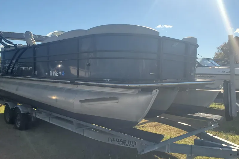 Slide: The Image of 2018 Starcraft SLS 3 pontoon boat on trailer under sunny sky. - 7