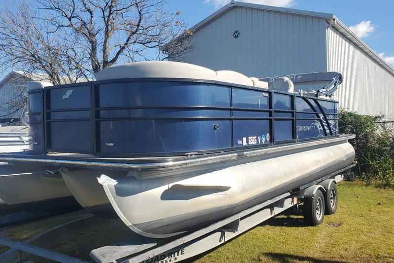 Slide: The Image of 2018 Starcraft SLS 3 pontoon boat on trailer, parked outdoors. - 8