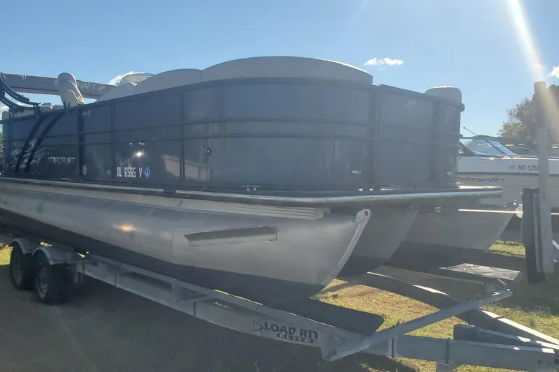 Slide: The Image of 2018 Starcraft SLS 3 pontoon boat on trailer under sunny sky. - 9