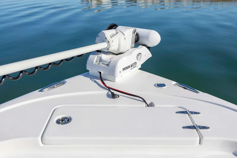 Slide: The Image of 2024 Sea Hunt Ultra 239 SE with Minn Kota trolling motor on calm water. - 11
