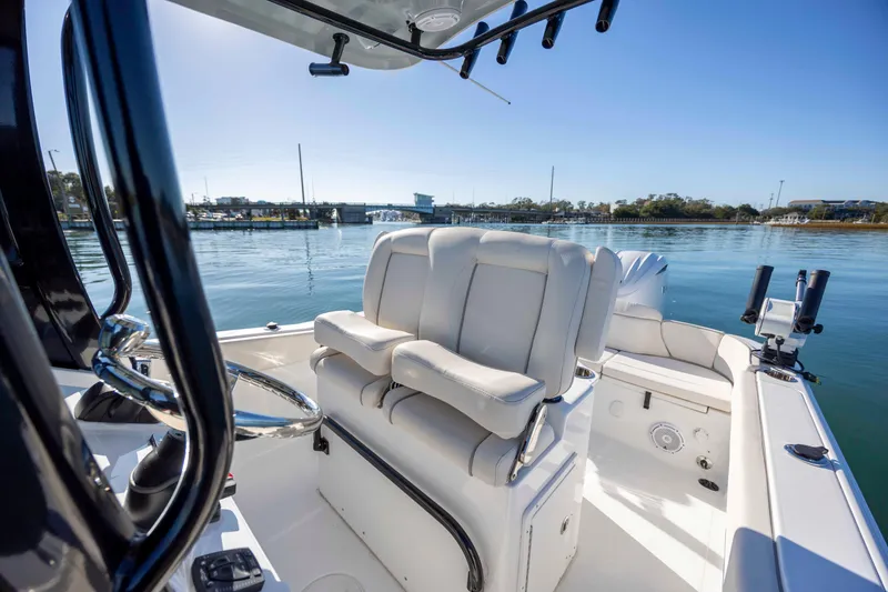 Slide: The Image of 2024 Sea Hunt Ultra 239 SE boat interior with comfortable seating and steering wheel. - 16