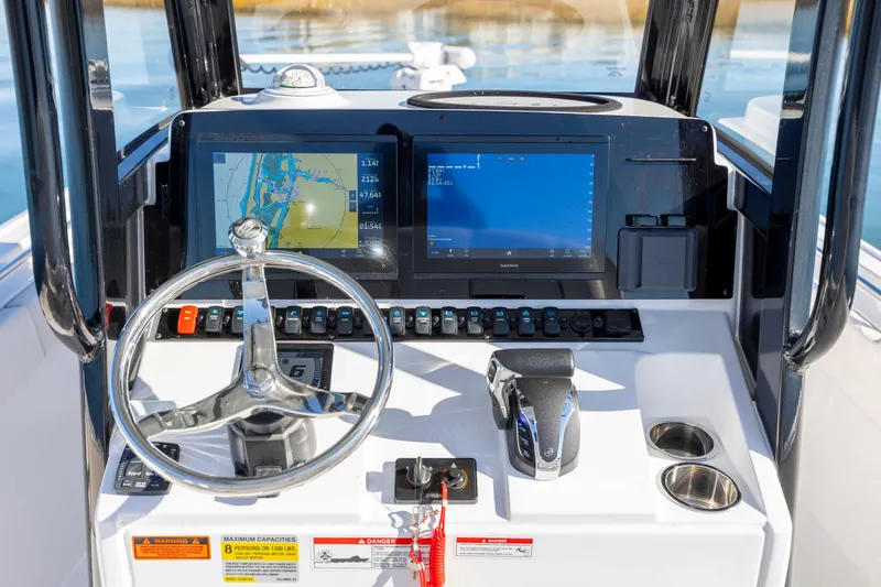Slide: The Image of 2024 Sea Hunt Ultra 239 SE boat dashboard with navigation screens and controls. - 18