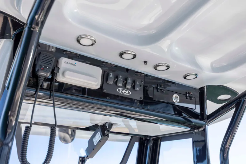 Slide: The Image of 2024 Sea Hunt Ultra 239 SE boat console with Garmin electronics and control switches. - 19