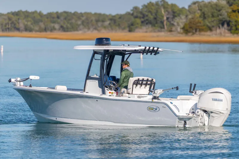 Slide: The Image of 2024 Sea Hunt Ultra 239 SE boat on calm water with Yamaha engine. - 2