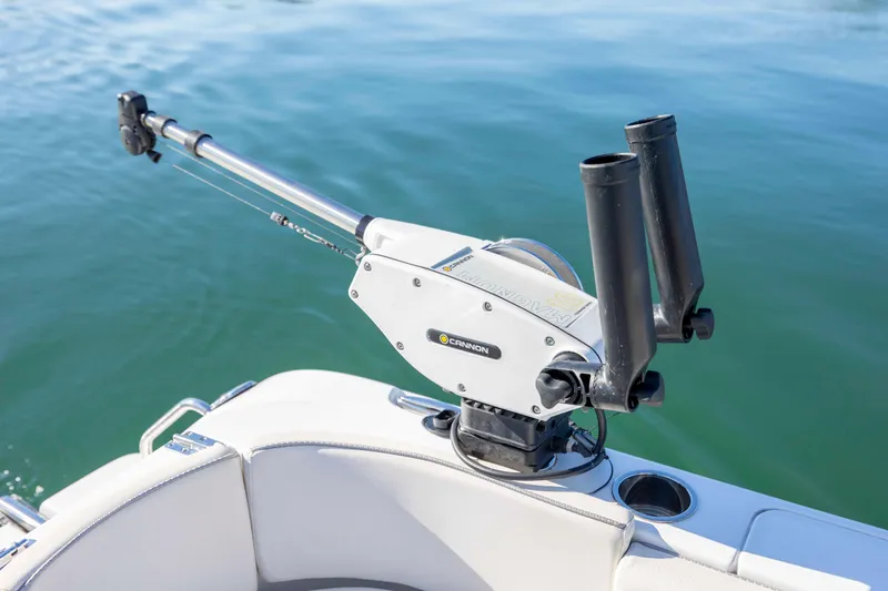 Slide: The Image of 2024 Sea Hunt Ultra 239 SE boat with mounted fishing rod holder on calm water. - 24