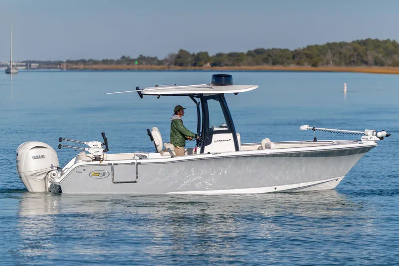 Slide: The Image of 2024 Sea Hunt Ultra 239 SE boat cruising on calm water. - 5