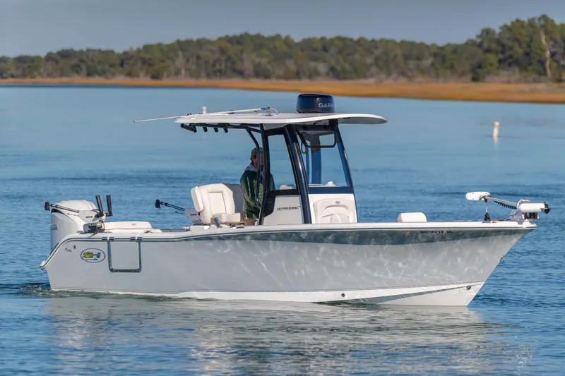 Slide: The Image of 2024 Sea Hunt Ultra 239 SE boat cruising on calm water. - 6