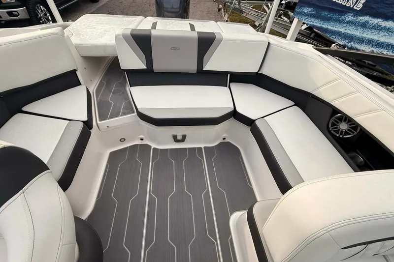 Slide: The Image of 2023 Regal 21 OBX boat interior with white and gray seating and flooring. - 10