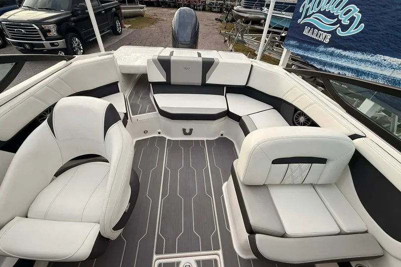 Slide: The Image of 2023 Regal 21 OBX boat interior with white and black seating, gray flooring. - 11