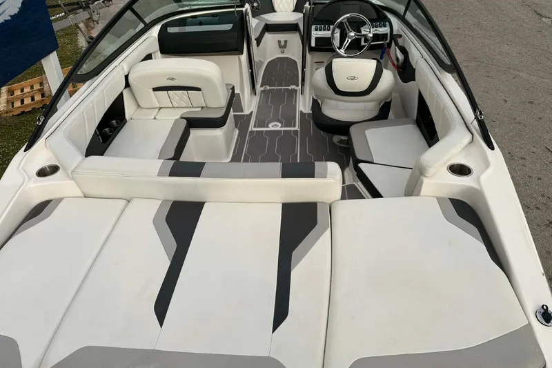 Slide: The Image of 2023 Regal 21 OBX boat interior with modern seating and steering wheel. - 12