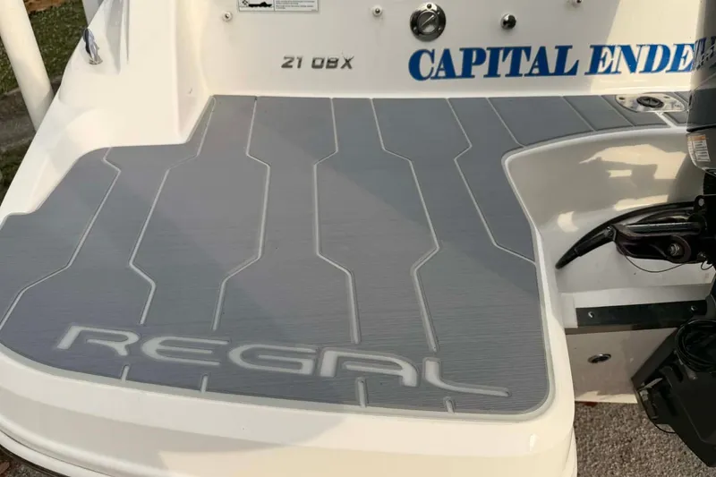 Slide: The Image of 2023 Regal 21 OBX boat deck with "Capital Endeavor" text and sleek design. - 14