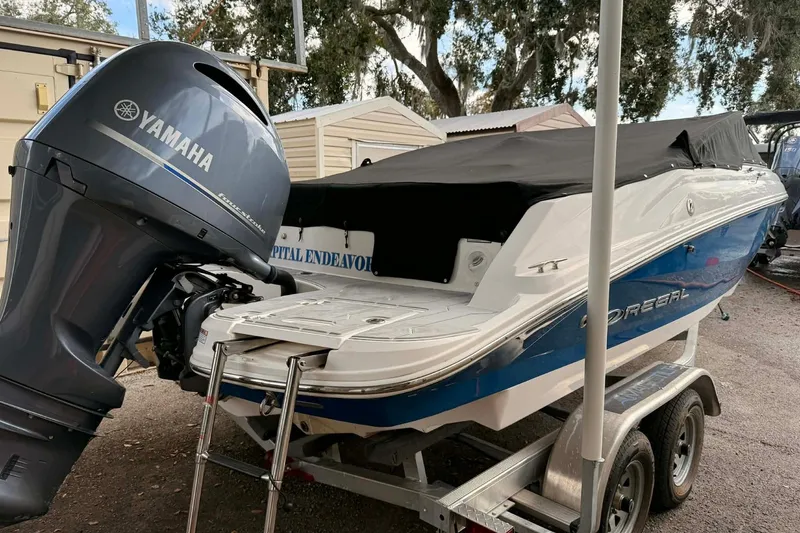 Slide: The Image of 2023 Regal 21 OBX boat with Yamaha outboard motor on trailer. - 3