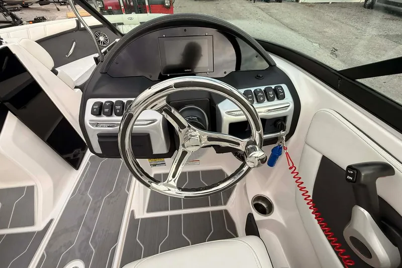 Slide: The Image of 2023 Regal 21 OBX boat dashboard with steering wheel and control panel. - 5