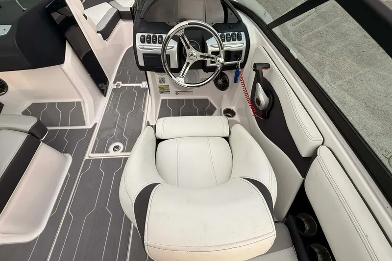 Slide: The Image of 2023 Regal 21 OBX boat interior with modern steering and seating design. - 7
