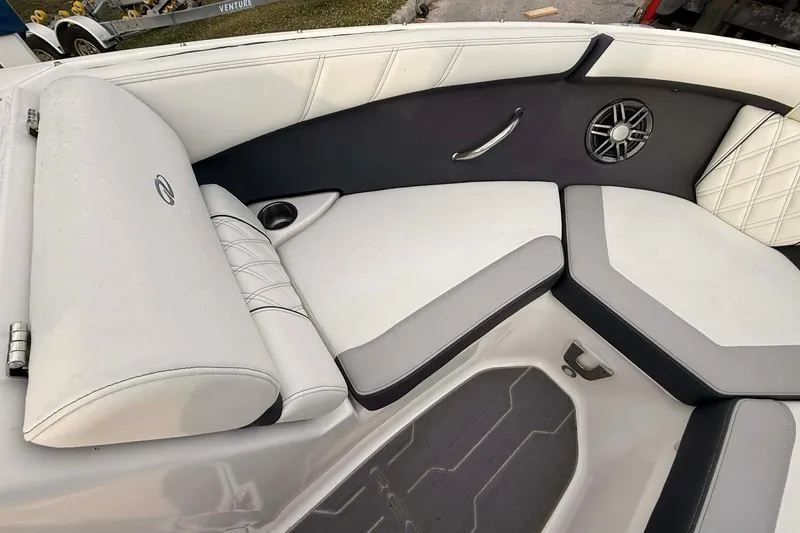 Slide: The Image of 2023 Regal 21 OBX boat interior with cushioned seating and speaker. - 9