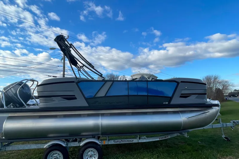The Image of 2026 Starcraft VX 20 R DH pontoon boat on trailer under blue sky. - 1