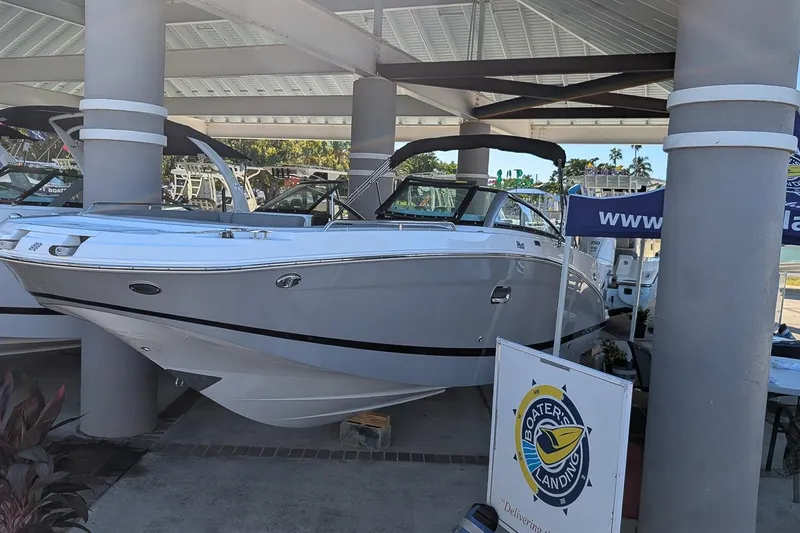 The Image of 2026 Four Winns HD5 OB boat displayed at a marina under a covered area. - 0