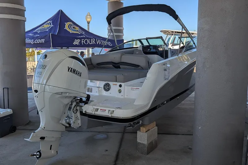 Slide: The Image of 2026 Four Winns HD5 OB boat with Yamaha 300 V6 outboard motor displayed at a marina. - 2