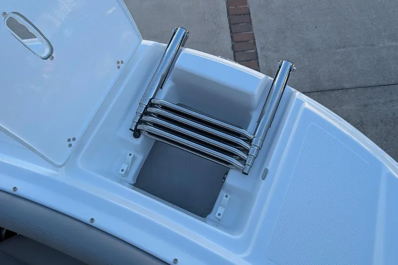 Slide: The Image of 2026 Four Winns HD5 OB boat with a retractable stainless steel ladder. - 22