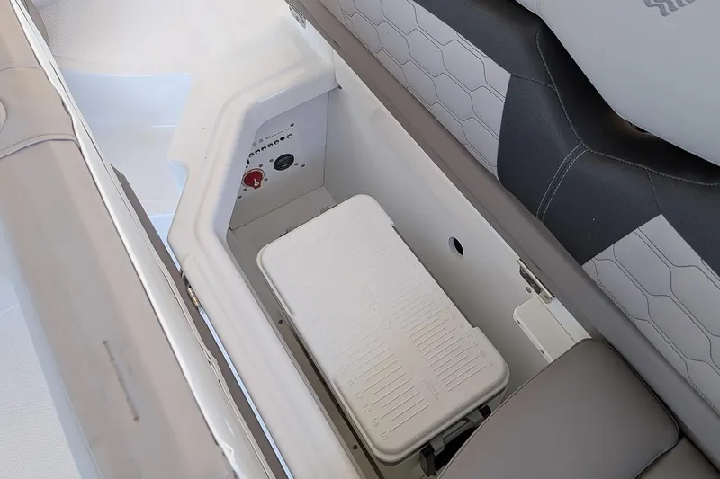 Slide: The Image of 2026 Four Winns HD5 OB boat storage compartment with cooler and control panel. - 7