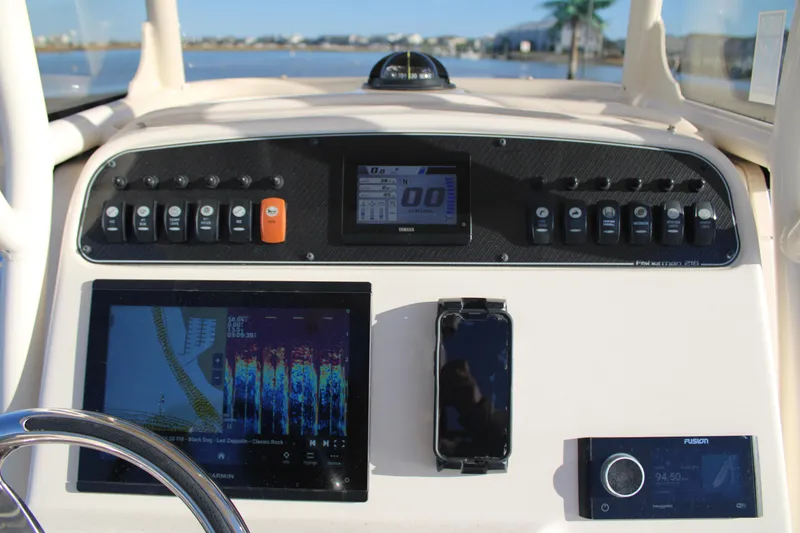 Slide: The Image of 2024 Grady-White Fisherman 216 dashboard with navigation and control systems. - 16